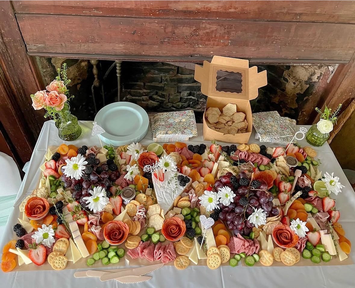 Brie Box grazing spread with fruit, cured meats, cheeses and flowers